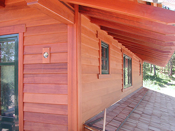 All heartwood redwood siding applied vertically.